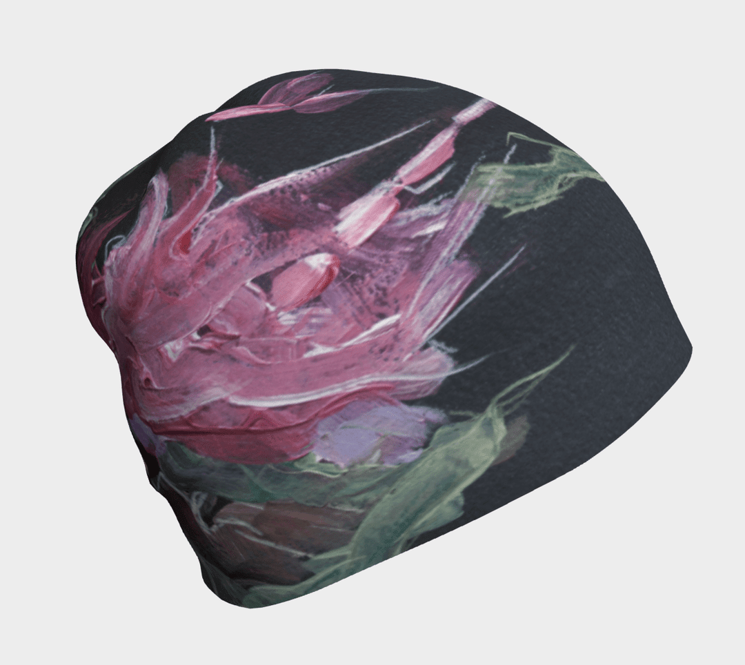 Une tuque noire avec un imprimé floral abstrait aux couleurs vives, rose et vert, vue de face.