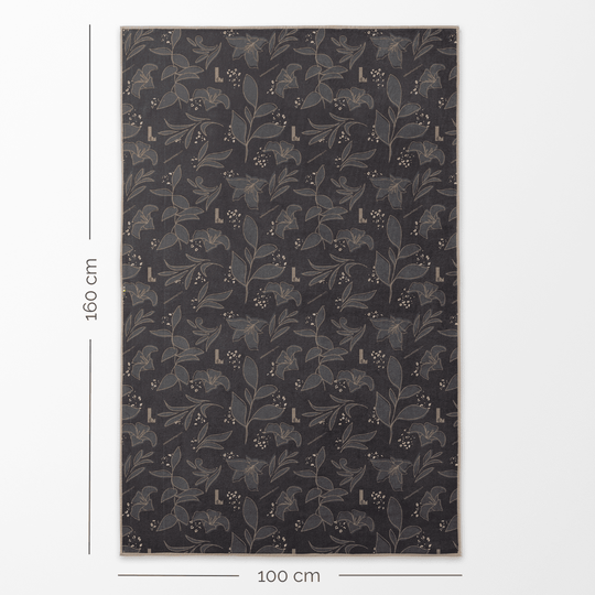 Le verso de la serviette artistique réversible XL Félins, affichant un motif floral foncé de 100 cm par 160 cm.