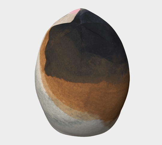 Top view of a relaxed fit beanie featuring abstract brushstrokes in navy, black, tan, and white.