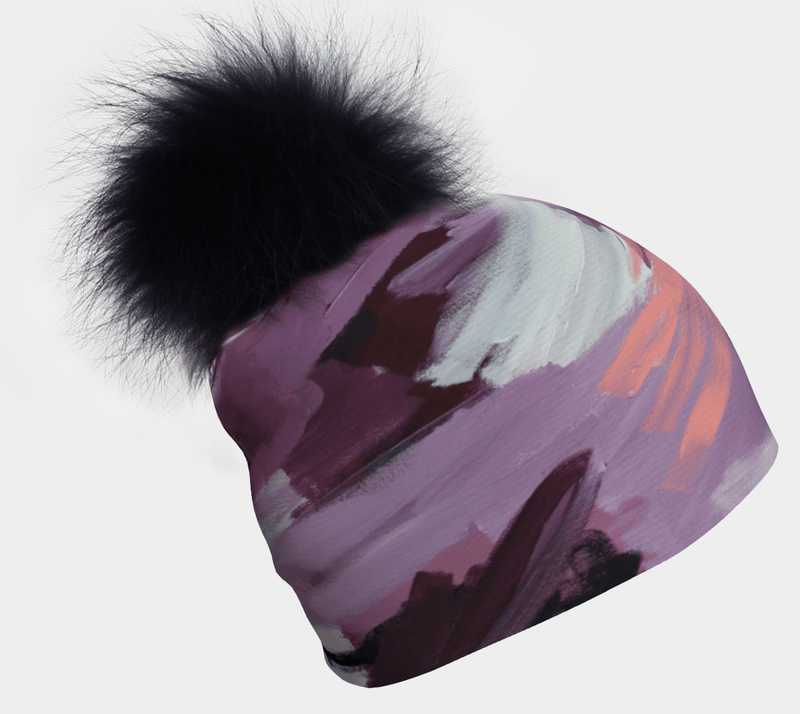 Tuque Tulipes montrant un art abstrait pastel et un pompon noir moelleux.