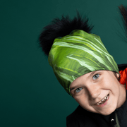 Boy making funny faces wearing the Green Light beanie by Andre Martel for the Lalita's Art Shop 22 collection. 