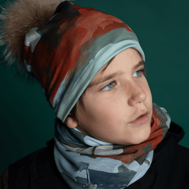 Young boy carrying the Lalita's Art Shop multifunctional tube. This bandana can be worn 10 different ways. Perfect for outdoor sports activities, camping and nature walks.