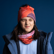 Young girl grimacing and wearing the Pink Graphonetrics beanie, with detachable pom, illustrated by artist Valéry Goulet from Quebec. This cap will add a feminine touch to your sportswear.