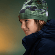 Boy pairing this abstract green, blue, white and black bamboo beanie hat with a navy winter jacket.