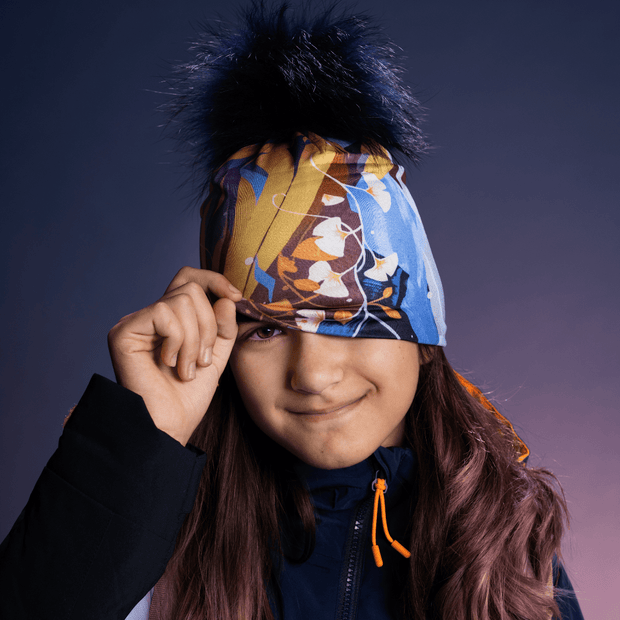 Teenager girl wearing the multicolor Spring Pompom toque from Ankhone for Lalita's Art Shop