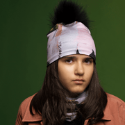 Young girl wearing the Light Pink and Black Modern Quilt Pompom Beanie by Catherine Parent for Lalita's Art Shop