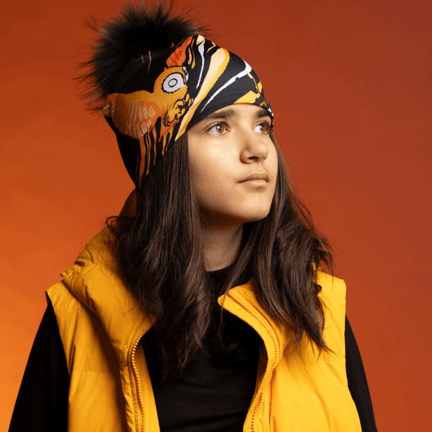 Teenager girl wearing the Orange Owl pompom bamboo beanie by Julie Rocheleau for the Lalita's Art Shop 24 collection.