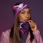 Sportive woman wearing the Magenta and Purple Owl Fleece tube and assorted beanie by Julie Rocheleau for Lalita's Art Shop
