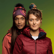 Woman wearing the Sunflower Read Beanie with Black Pompom from Zaire with the friend wearing the Sunflower Green Tube as hair Scrunchie. Lalita's Art Shop 24 Collection