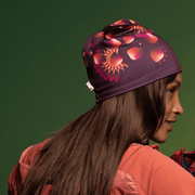 Woman facing backwards wearing the Red Sunflower Bamboo Beanie by Zaire for Lalita's Art Shop 24 collection