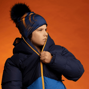 Kid wearing the Navy and Orange Beanie with Navy Pompom by Zaire for Lalita's Art Shop