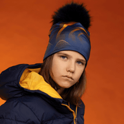 Boy wearing the Navy Pompom Sunrise Beanie by Zaire for the Lalita's Art Shop 24 collection