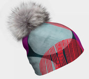 Left side view of the Teal Dots bamboo beanie hat. A magenta, teal and red toque