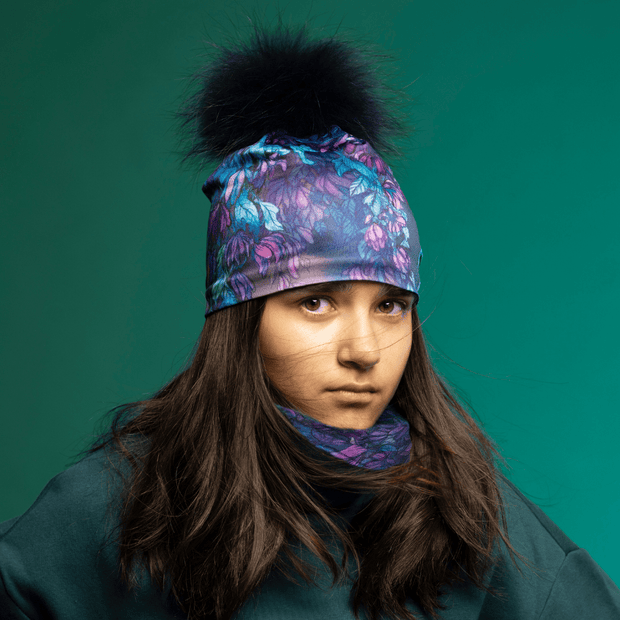 Teenager girl wearing a pompom beanie with the assorted Wisteria Purple and Teal Neckwear by Claire Anghinolfi for the Lalita's Art Shop 24-25 Collection